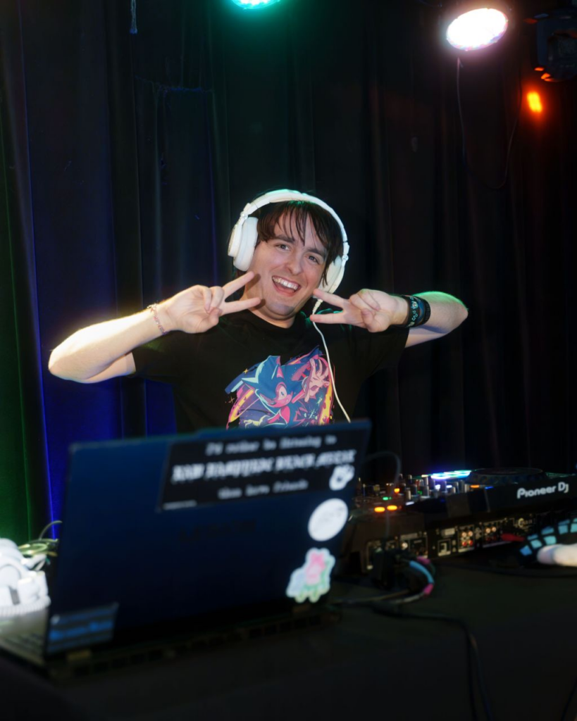 Me, DJ Noisy Pegasus, posing behind the decks at Gotta Glo Fast Columbus